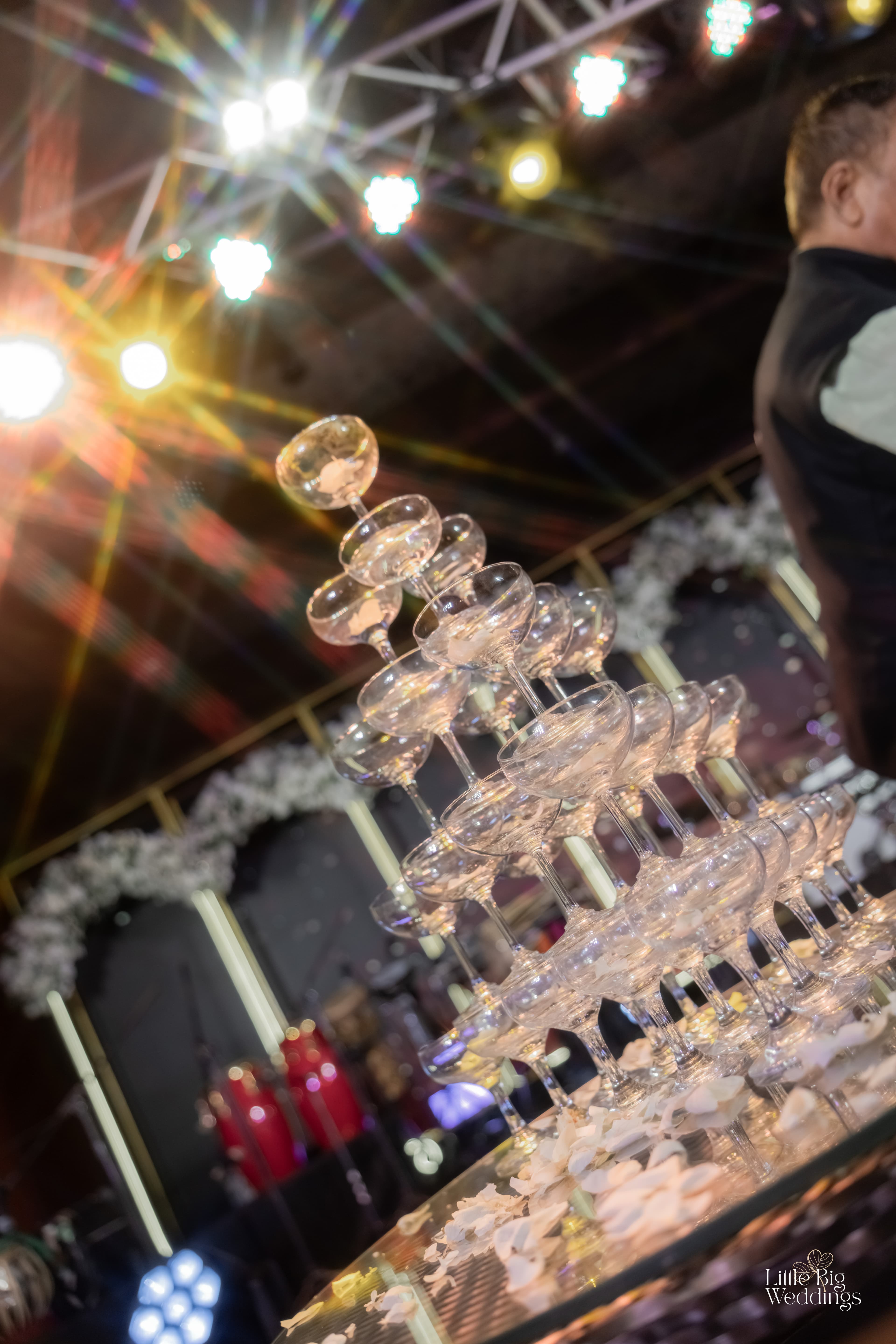 A tower of champagne glasses catching the light at an Arika gala