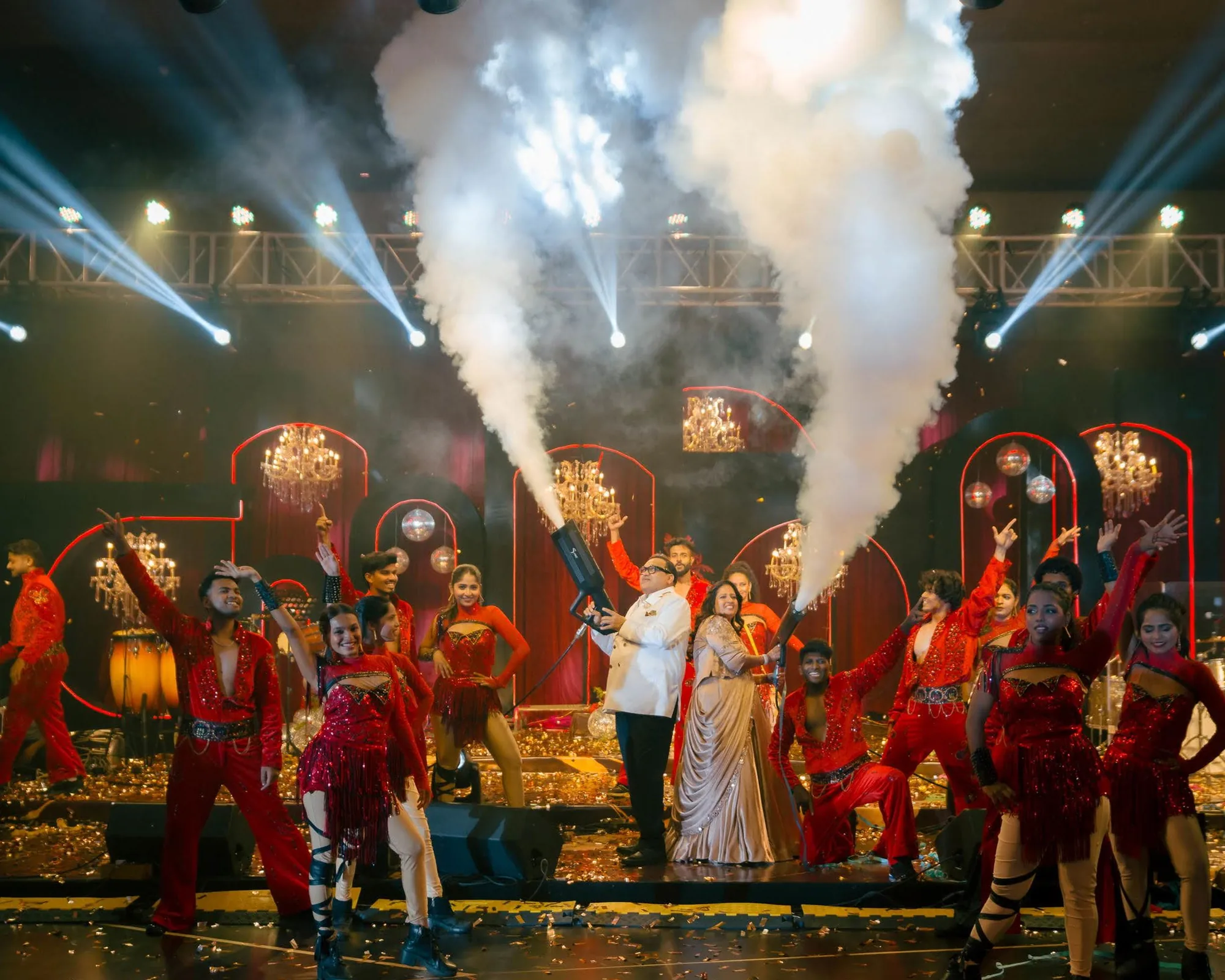 The finale of a celebration produced by Arika Event — dancers, confetti and cold-pyro jets on a lit stage