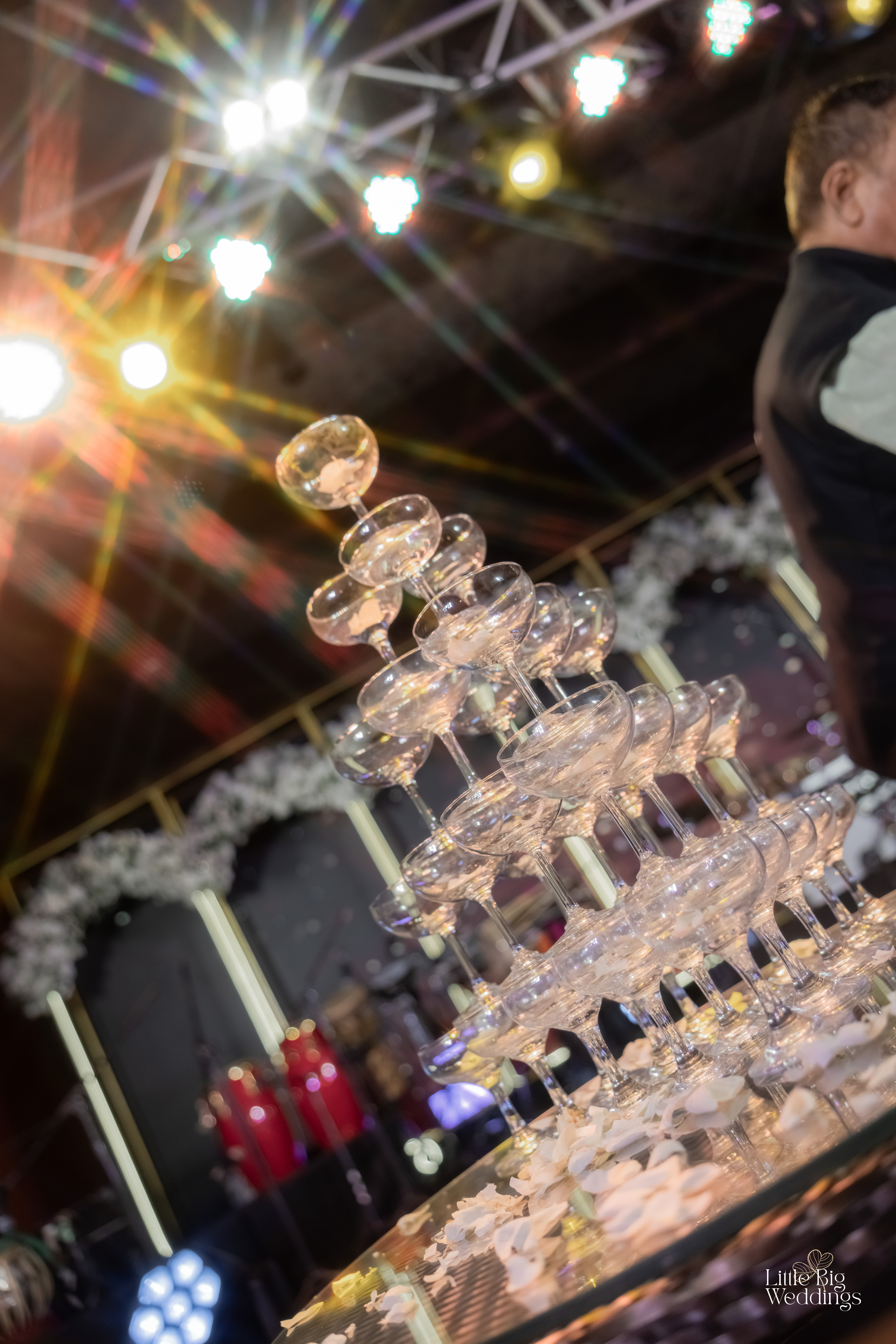 A tower of champagne glasses catching the light at a gala night